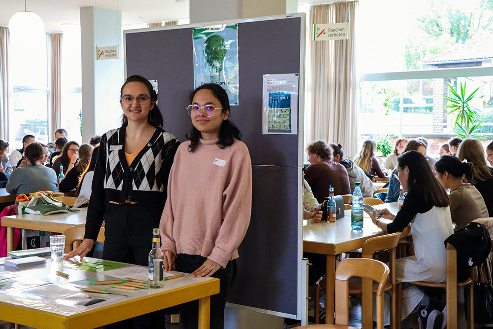 Olha und Reema sind Wohntutorinnen in Jena und sehr zufrieden mit dem interaktiven Format der Veranstaltung. Sie betreuen den Stand zum Energiesparen, an dem die Studierenden Fragen be-antworten und Preise gewinnen können.